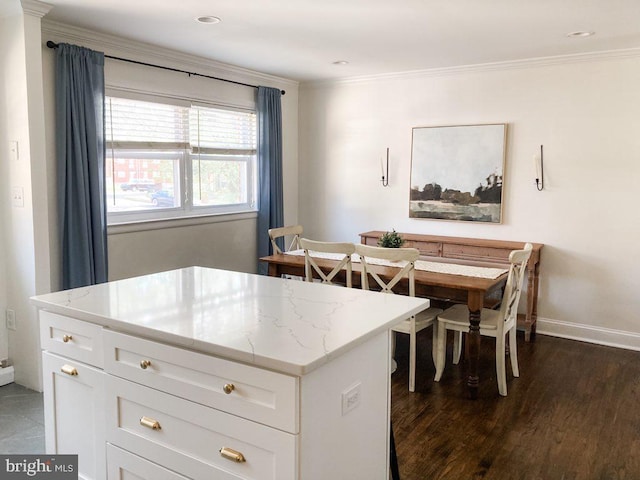 dining room with baseboards, dark wood-style floors, and ornamental molding