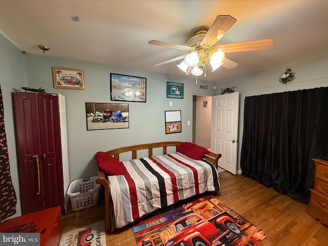 bedroom featuring a ceiling fan and wood finished floors