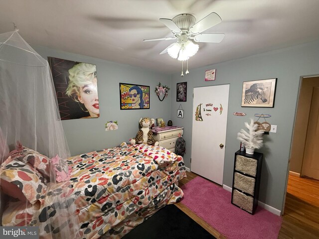 bedroom with wood finished floors and a ceiling fan