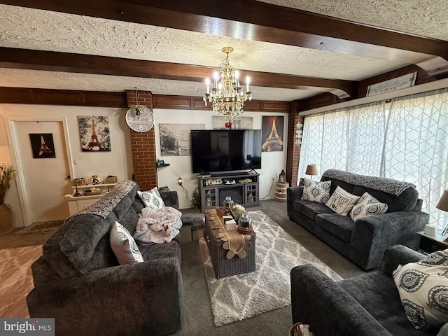 carpeted living room featuring beam ceiling, a textured ceiling, a chandelier, and a healthy amount of sunlight