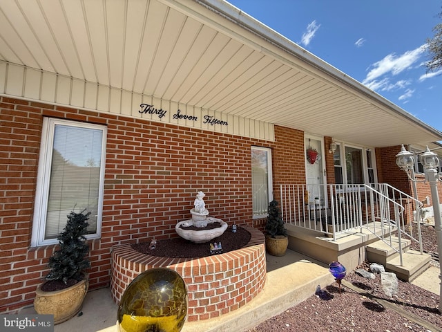 property entrance featuring brick siding