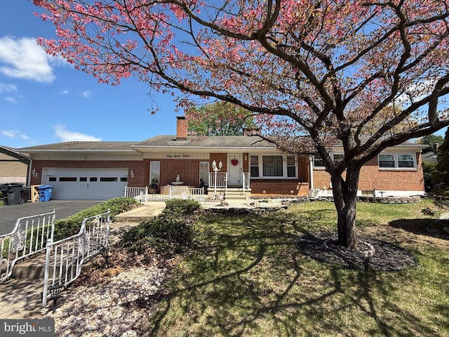 ranch-style house with driveway, a chimney, brick siding, and a garage