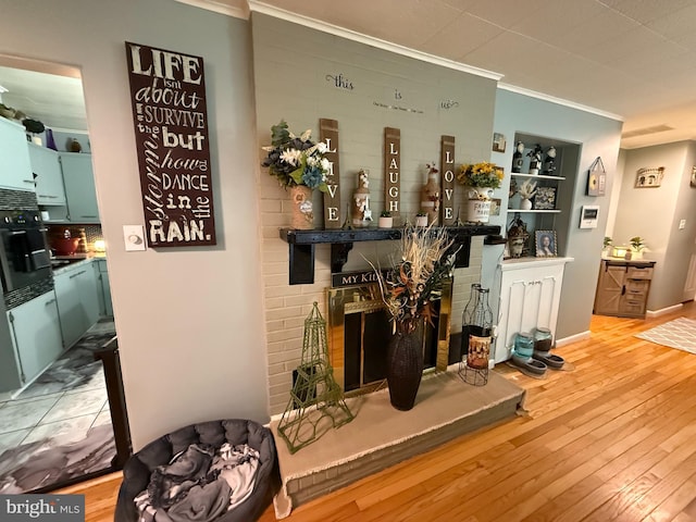 bar with hardwood / wood-style floors, ornamental molding, and a brick fireplace