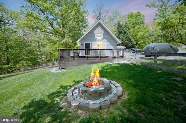 89 Cindys Way, Front Royal, VA 22630 - back of property featuring a lawn, a fenced backyard, a fire pit, and a deck