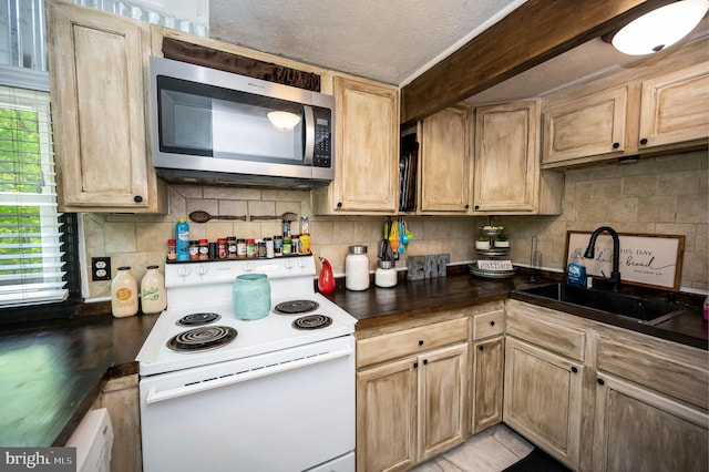 89 Cindys Way, Front Royal, VA 22630 - kitchen featuring white range with electric stovetop, dark countertops, a sink, stainless steel microwave, and tasteful backsplash