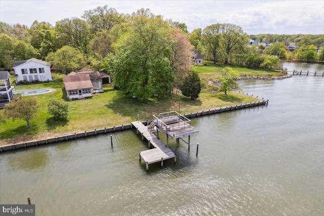 dock area with a yard and a water view