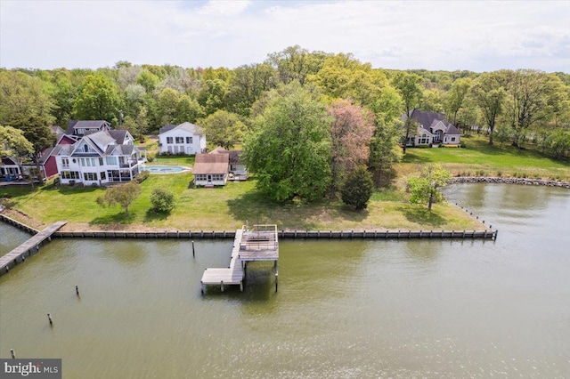 drone / aerial view with a water view and a forest view