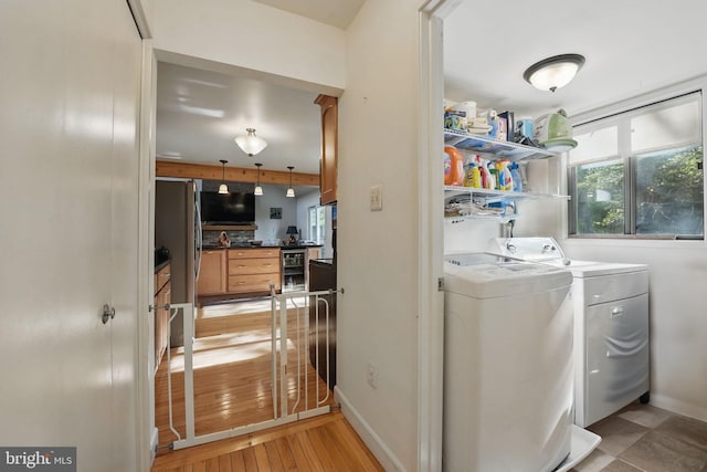 9601 Tinsmith Ln, Burke, VA 22015 - clothes washing area with beverage cooler, baseboards, laundry area, and independent washer and dryer