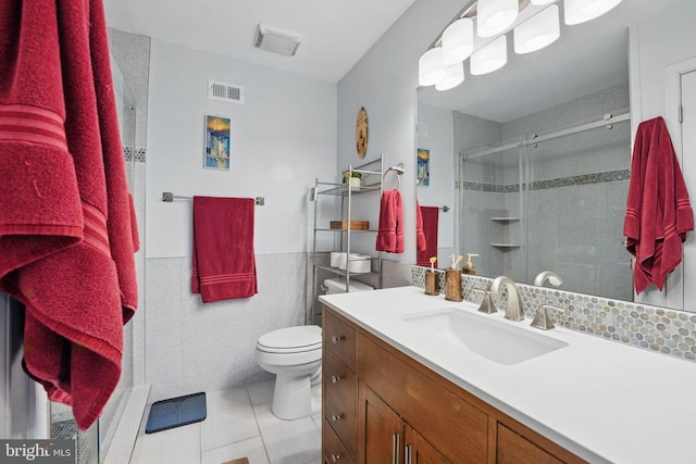 9601 Tinsmith Ln, Burke, VA 22015 - bathroom with vanity, toilet, tile walls, visible vents, and a stall shower