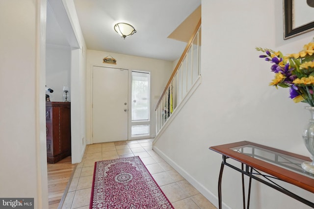 9601 Tinsmith Ln, Burke, VA 22015 - foyer entrance with baseboards, stairs, and light tile patterned floors