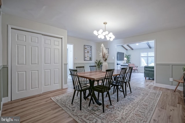 763 N Egg Harbor Rd, Hammonton, NJ 08037 - dining space with a chandelier, light wood-style flooring, a wainscoted wall, and a decorative wall