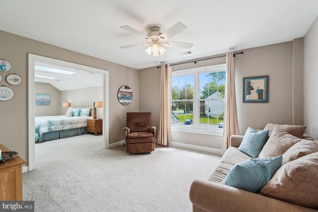 interior space with a ceiling fan, visible vents, a skylight, and baseboards
