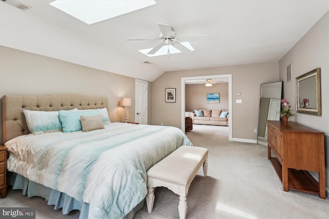 bedroom with visible vents, a ceiling fan, light carpet, and lofted ceiling with skylight