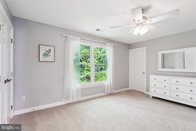 unfurnished bedroom with baseboards, visible vents, and light carpet