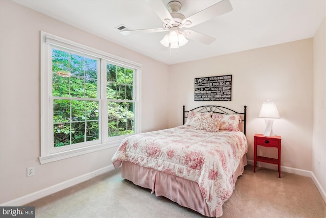bedroom featuring visible vents, ceiling fan, carpet floors, and baseboards