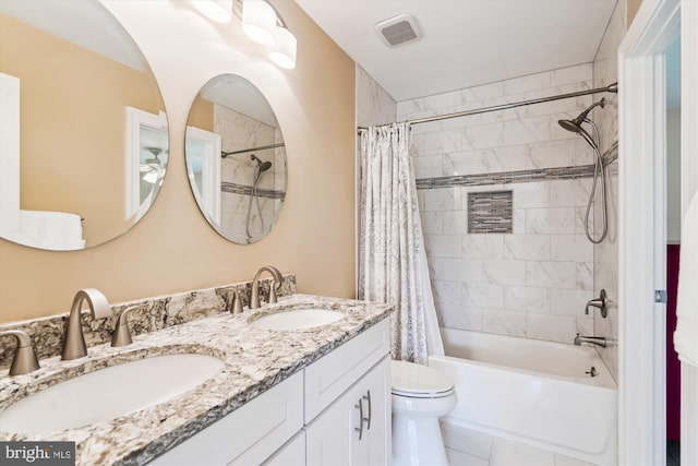 full bathroom featuring shower / tub combo with curtain, visible vents, toilet, and a sink