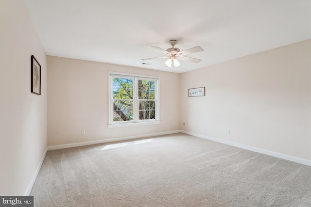 empty room featuring baseboards, visible vents, a ceiling fan, and carpet