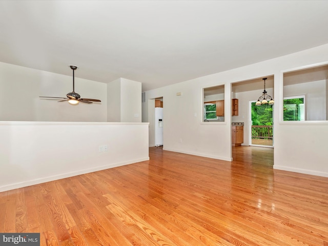 10924 Rawley Rd, New Market, MD 21774 - unfurnished room featuring light wood-type flooring, a chandelier, ceiling fan, and baseboards