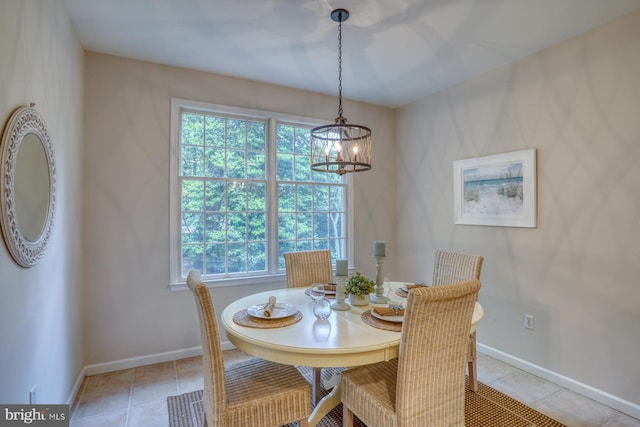 dining room with a chandelier, healthy amount of natural light, baseboards, and light tile patterned floors