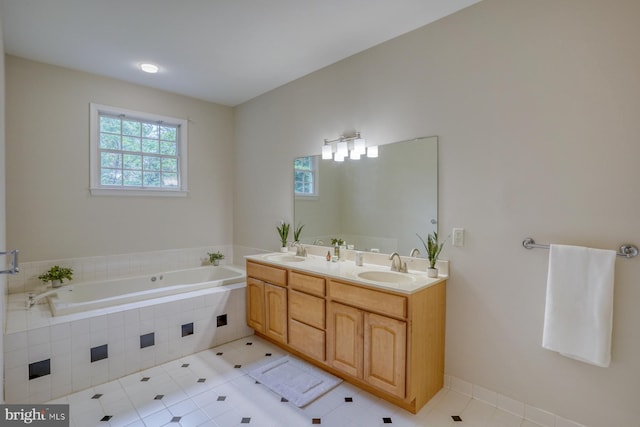 bathroom with a garden tub, tile patterned floors, and double vanity