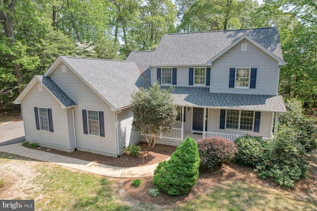 traditional-style house with a shingled roof and a porch