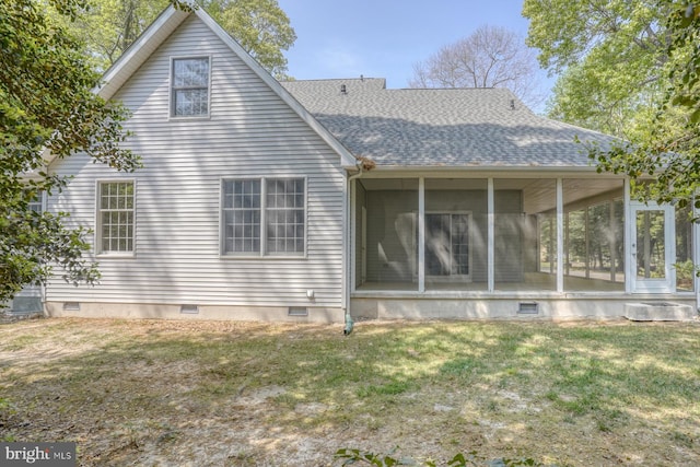back of property with a sunroom, crawl space, roof with shingles, and a yard