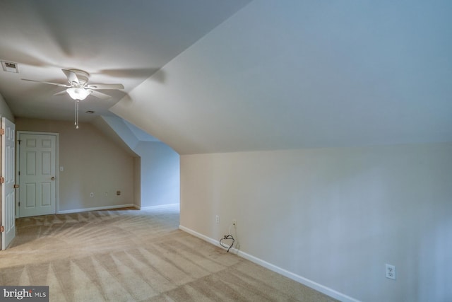 bonus room featuring a ceiling fan, baseboards, light colored carpet, and lofted ceiling