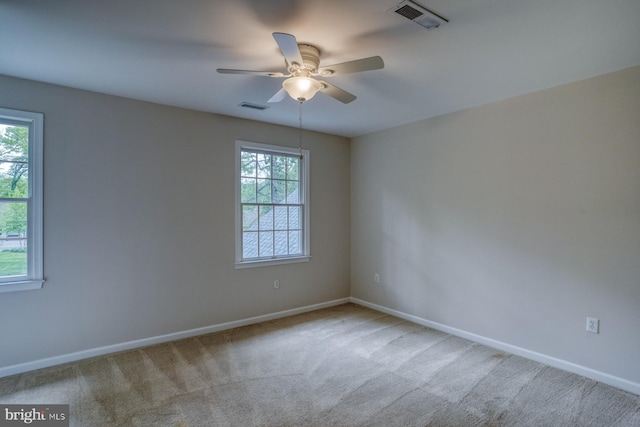 unfurnished room featuring carpet floors, baseboards, and a ceiling fan