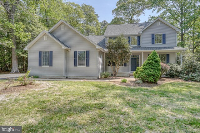 traditional-style home with covered porch and a front yard