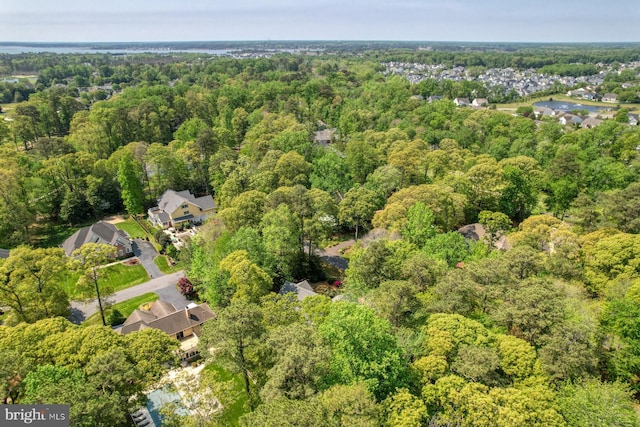 aerial overview of property's location with a heavily wooded area