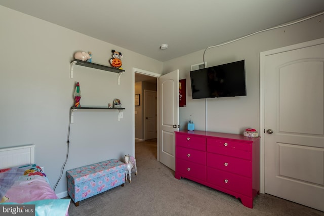 bedroom with visible vents and carpet