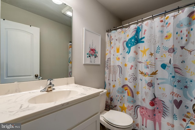 bathroom with toilet, a shower with shower curtain, and vanity