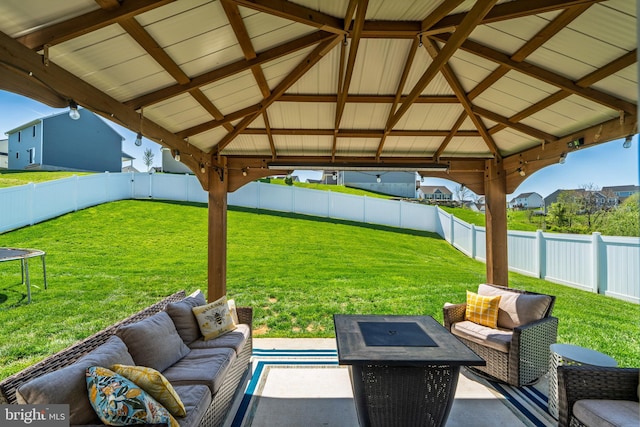 view of patio with a gazebo, an outdoor living space, and a fenced backyard