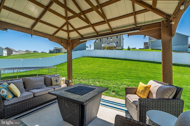 view of patio / terrace with a gazebo, a trampoline, outdoor lounge area, and fence