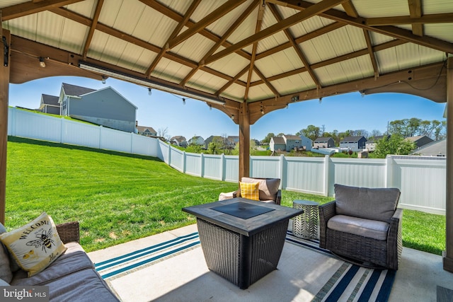 view of patio with a gazebo, a residential view, a fenced backyard, and an outdoor hangout area