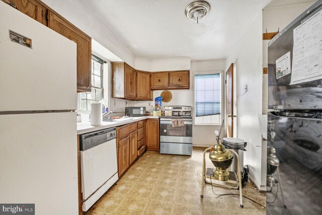 5610 Gallatin Pl, Hyattsville, MD 20781 - kitchen featuring freestanding refrigerator, electric range, dishwashing machine, and brown cabinetry