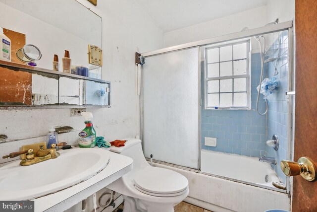 5610 Gallatin Pl, Hyattsville, MD 20781 - bathroom featuring a sink, toilet, and bath / shower combo with glass door