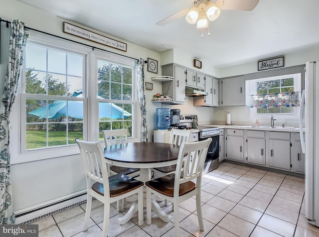 dining area featuring a ceiling fan and light tile patterned floors