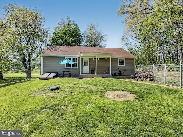 back of property with fence and a yard