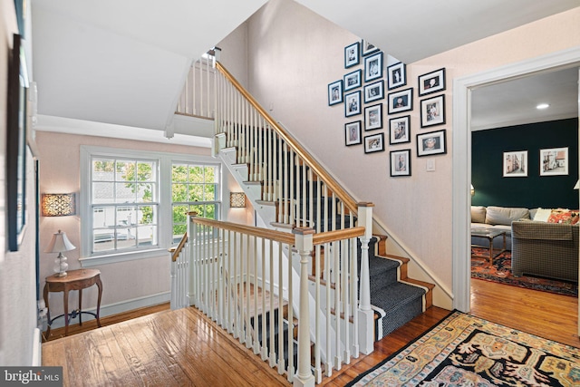 stairs with hardwood / wood-style flooring and baseboards