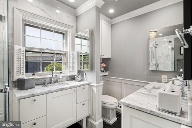 bathroom featuring crown molding, a marble finish shower, a decorative wall, vanity, and a wainscoted wall