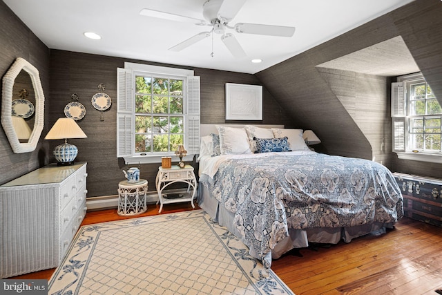 bedroom with wood-type flooring, ceiling fan, and recessed lighting