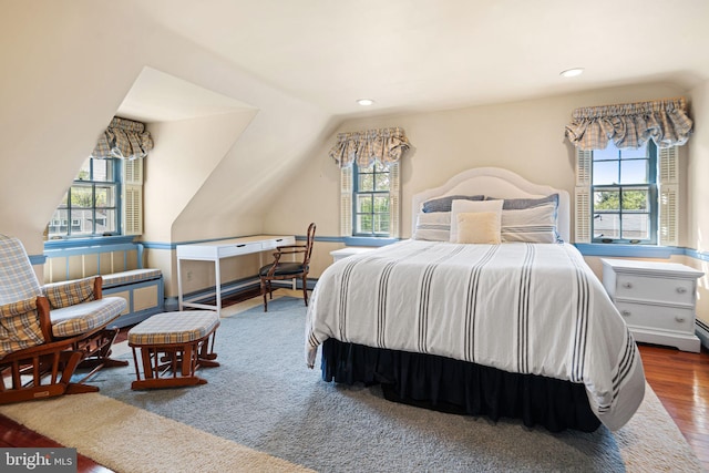 bedroom with multiple windows, wood finished floors, vaulted ceiling, and recessed lighting