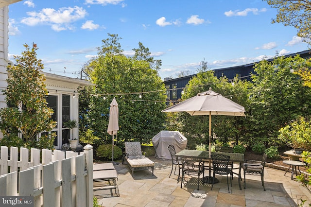 view of patio / terrace featuring outdoor dining area and fence