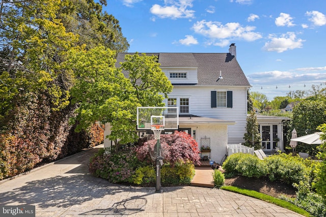 back of property with a chimney