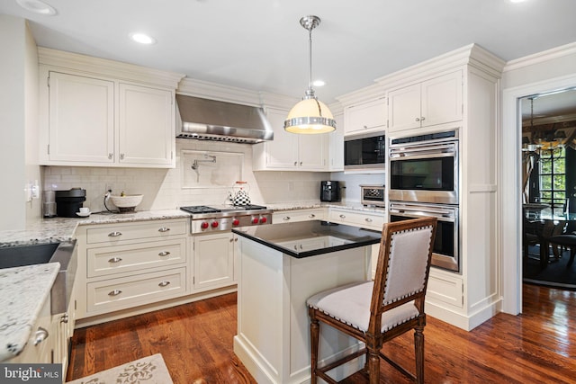 kitchen with wall chimney range hood, appliances with stainless steel finishes, dark wood-style flooring, tasteful backsplash, and recessed lighting