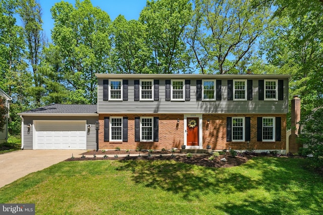 colonial inspired home featuring an attached garage, a front lawn, brick siding, and concrete driveway