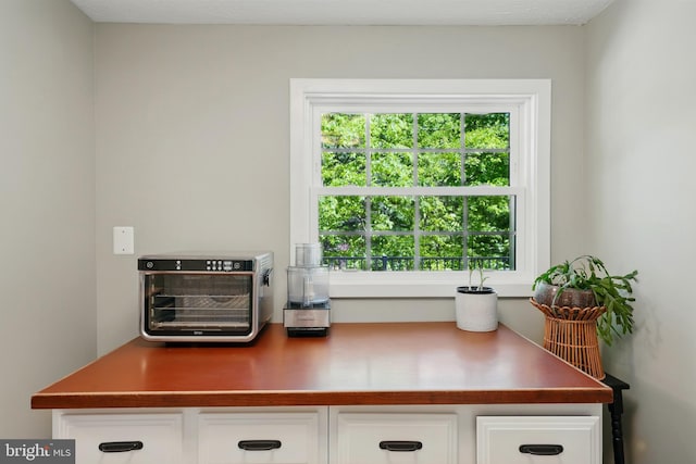 interior details with a toaster and white cabinetry
