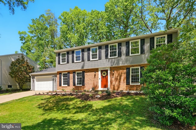 colonial-style house featuring brick siding, an attached garage, driveway, and a front lawn