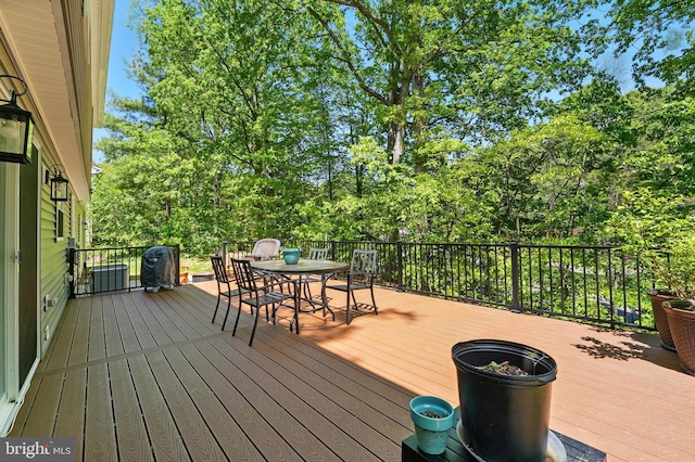 wooden terrace with outdoor dining area